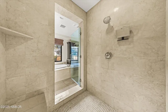a view of a patio with table and chairs under an umbrella