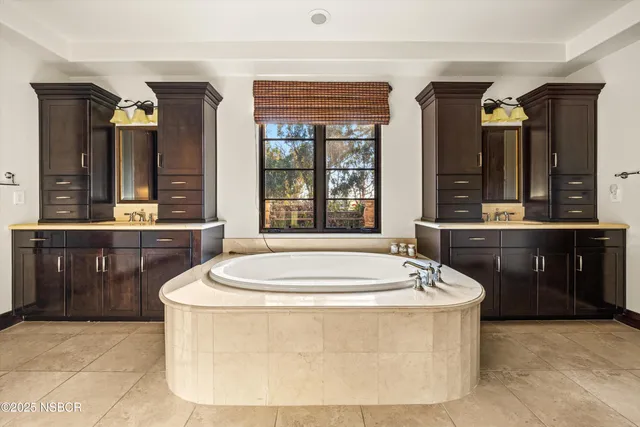 a patio with a table and chairs under an umbrella