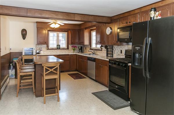 85 Rinaldo Road Weymouth, MA 02191 - Photo 4 of 13 a kitchen with stainless steel appliances granite countertop a stove top oven a refrigerator a dining table and chairs