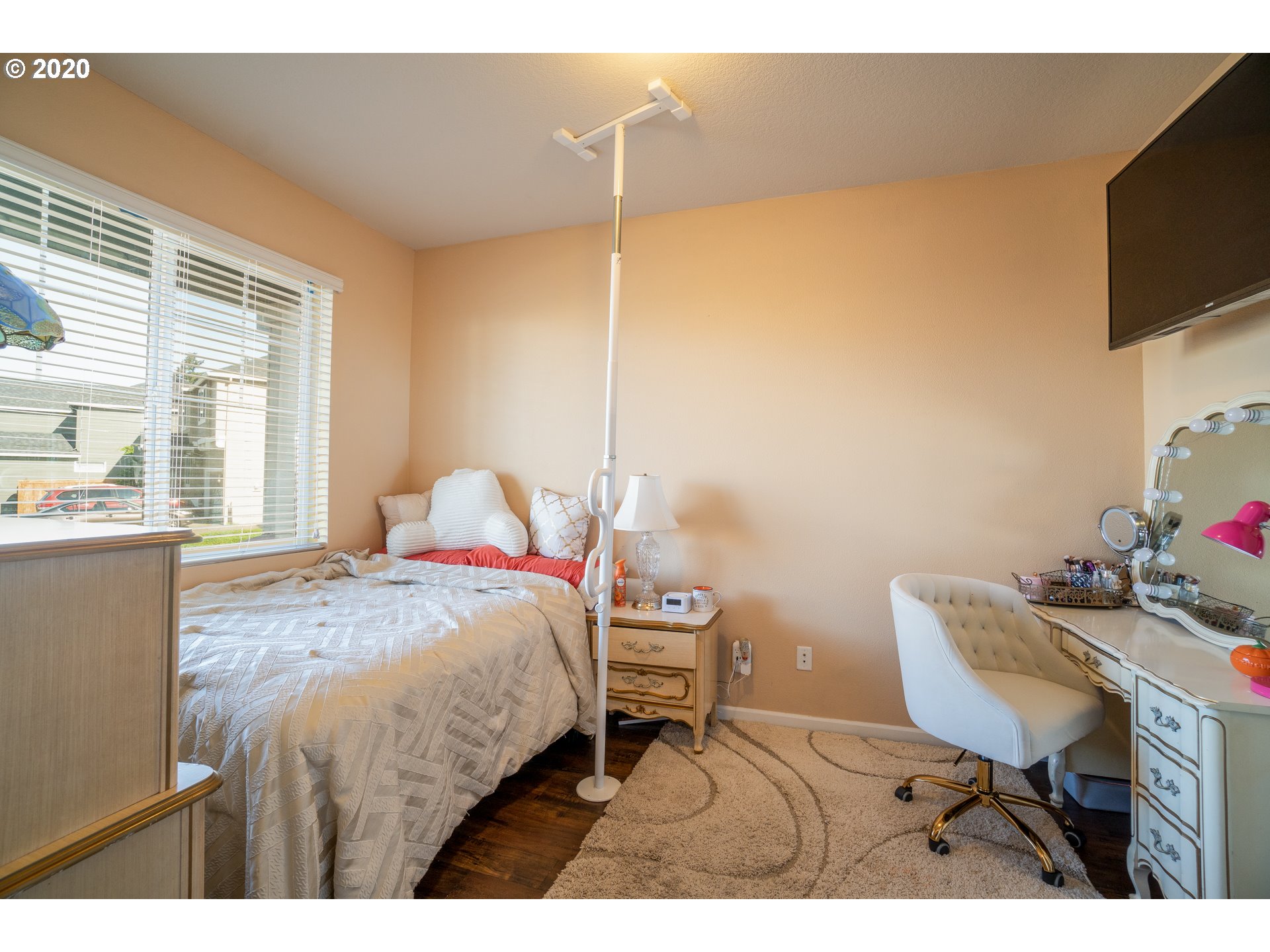818 North Gibert Court Ridgefield, WA 98642 - Photo 11 of 30 a bedroom with a bed window and a flat screen tv