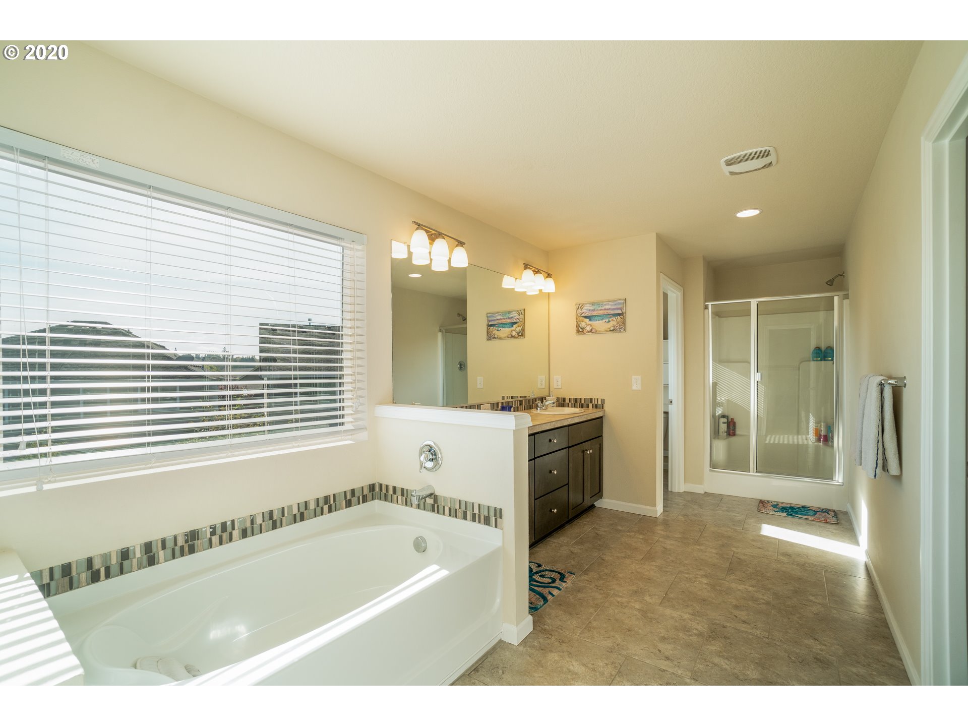 818 North Gibert Court Ridgefield, WA 98642 - Photo 14 of 30 a bathroom with a tub a sink a mirror and a shower