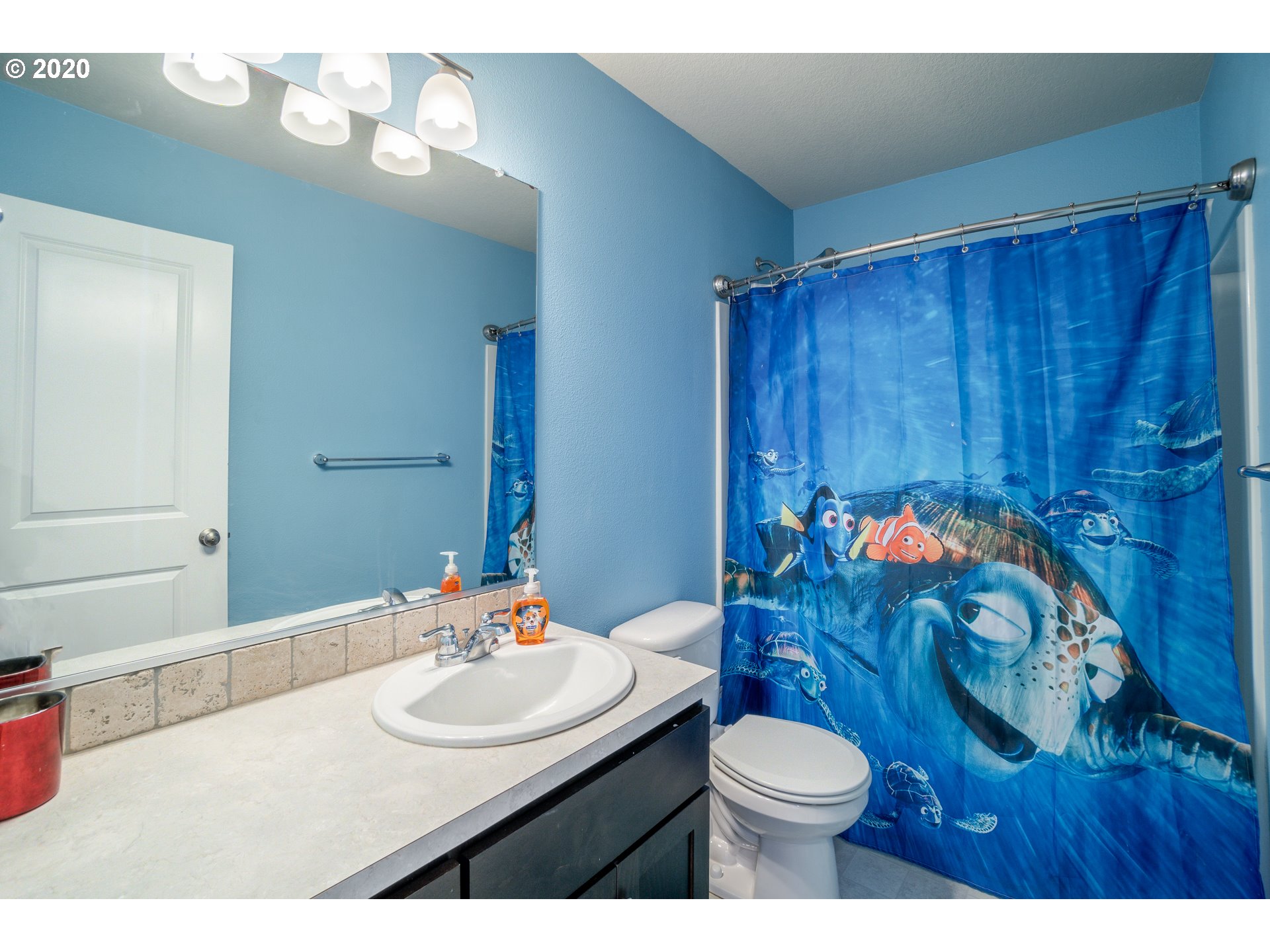 818 North Gibert Court Ridgefield, WA 98642 - Photo 20 of 30 a bathroom with a sink vanity mirror and toilet