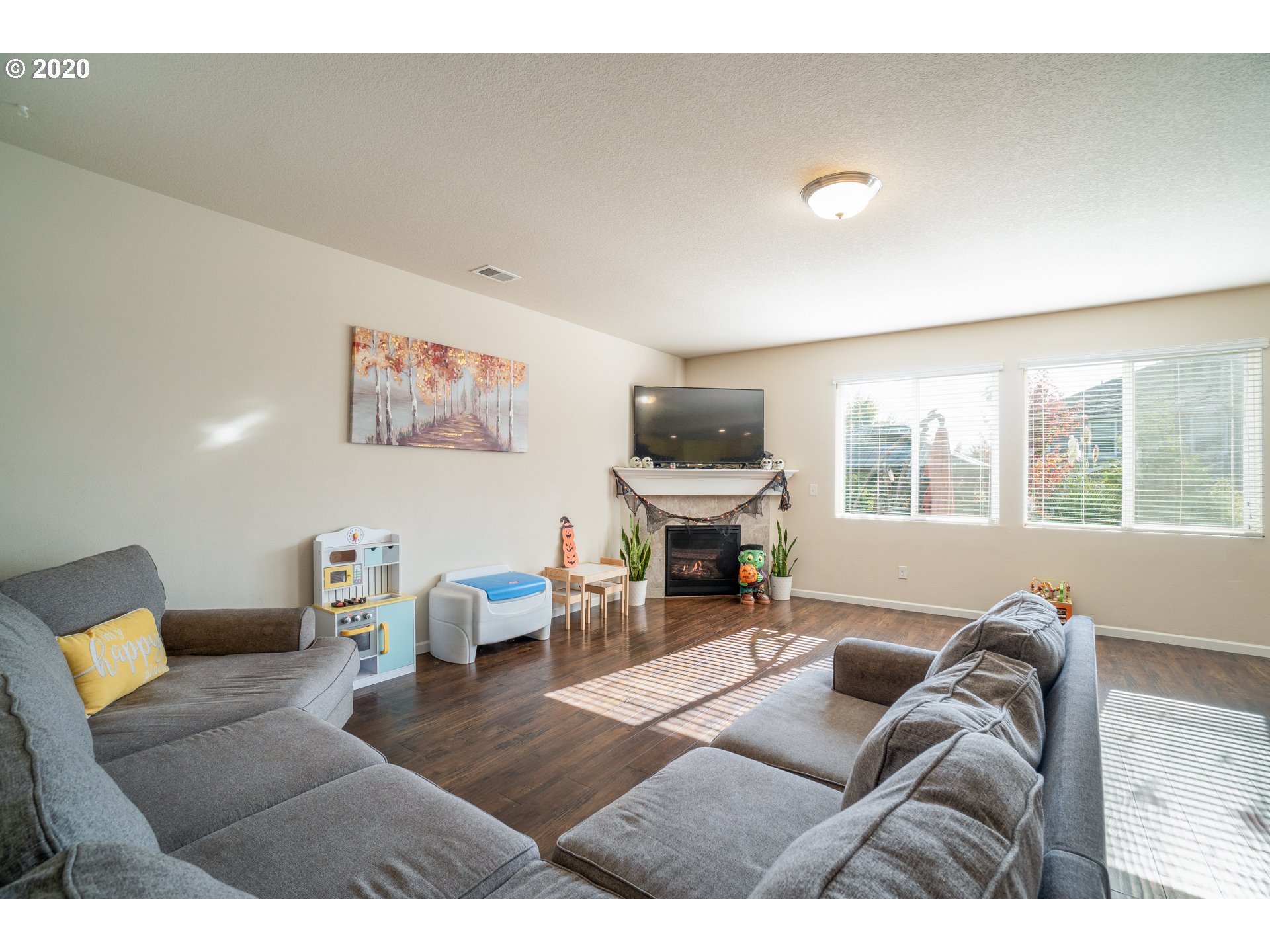 818 North Gibert Court Ridgefield, WA 98642 - Photo 7 of 30 a living room with furniture a piano and a large window