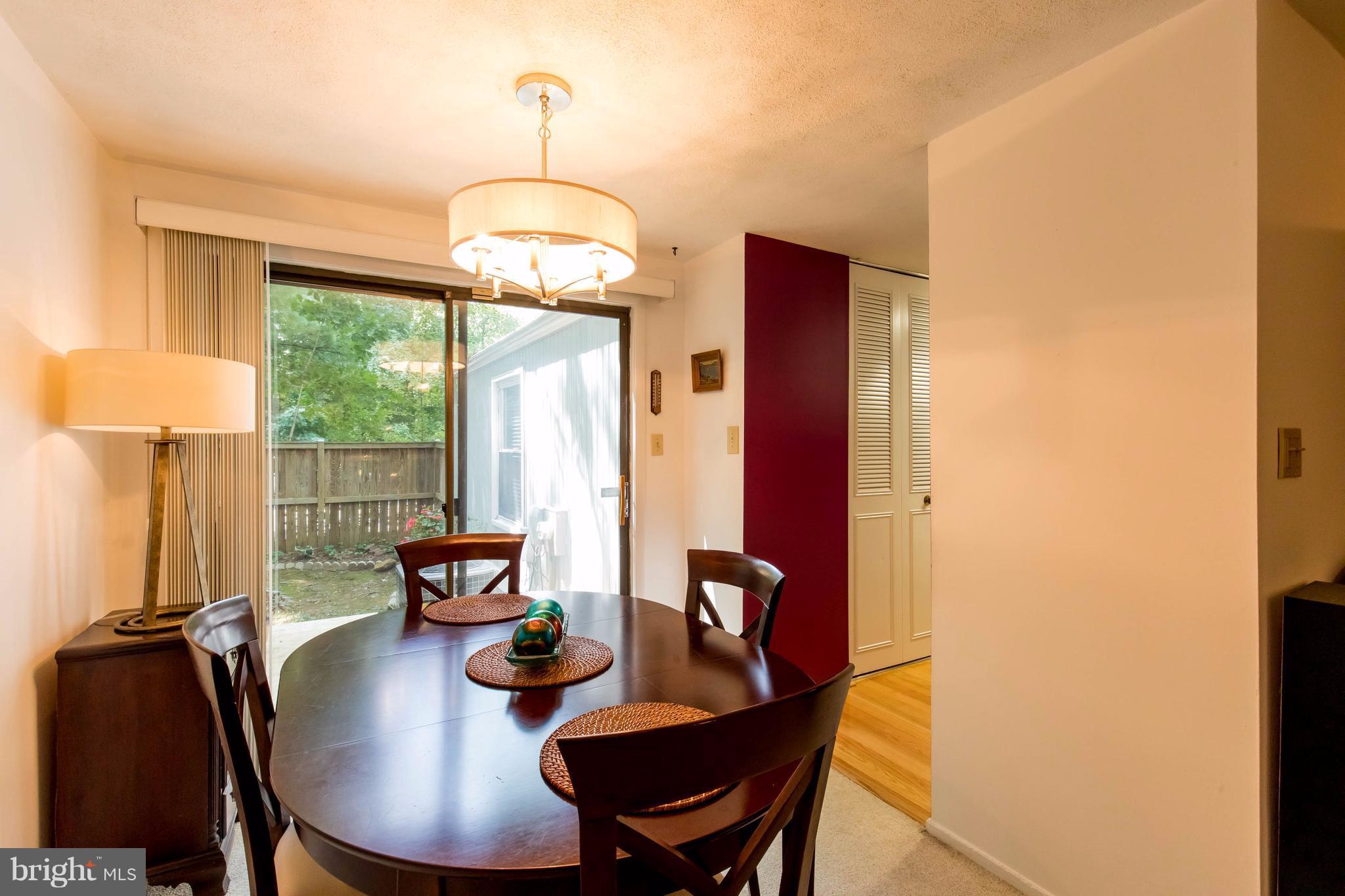 12255 Turkey Wing Court Reston, VA 20191 - Photo 11 of 30 a view of a dining room with furniture window and outside view