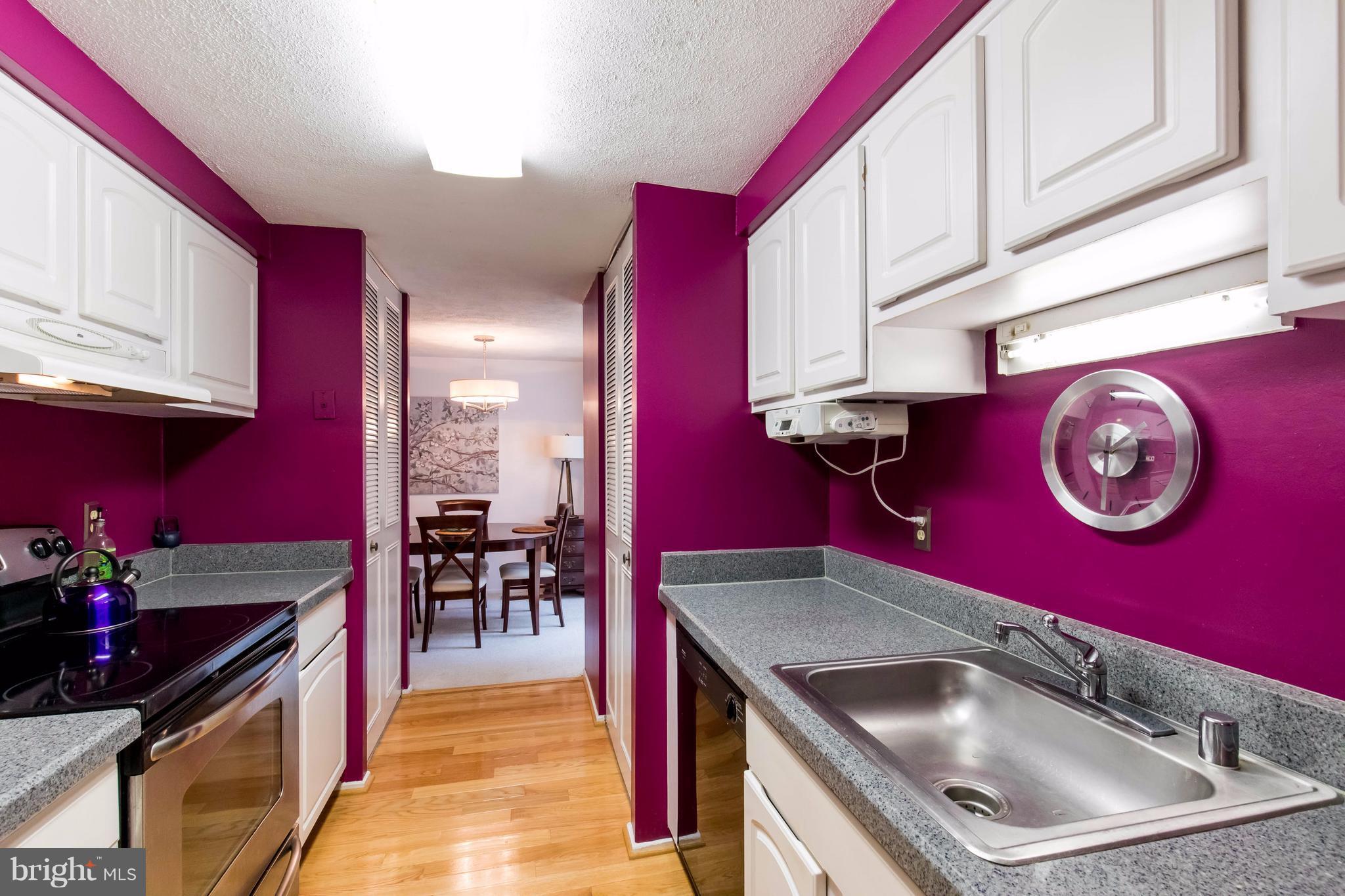 12255 Turkey Wing Court Reston, VA 20191 - Photo 14 of 30 a kitchen with stainless steel appliances granite countertop a red stove top oven a sink and dishwasher