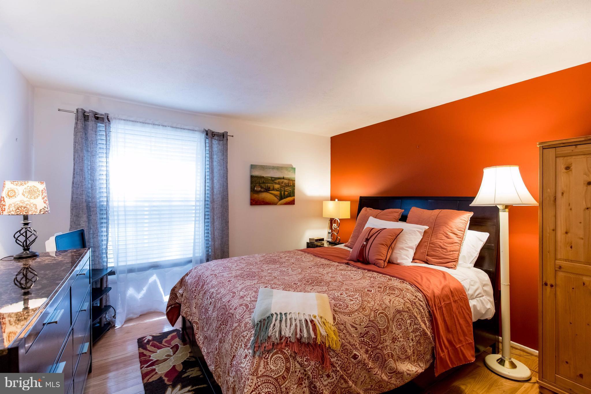 12255 Turkey Wing Court Reston, VA 20191 - Photo 17 of 30 a bedroom with a bed and wooden floor