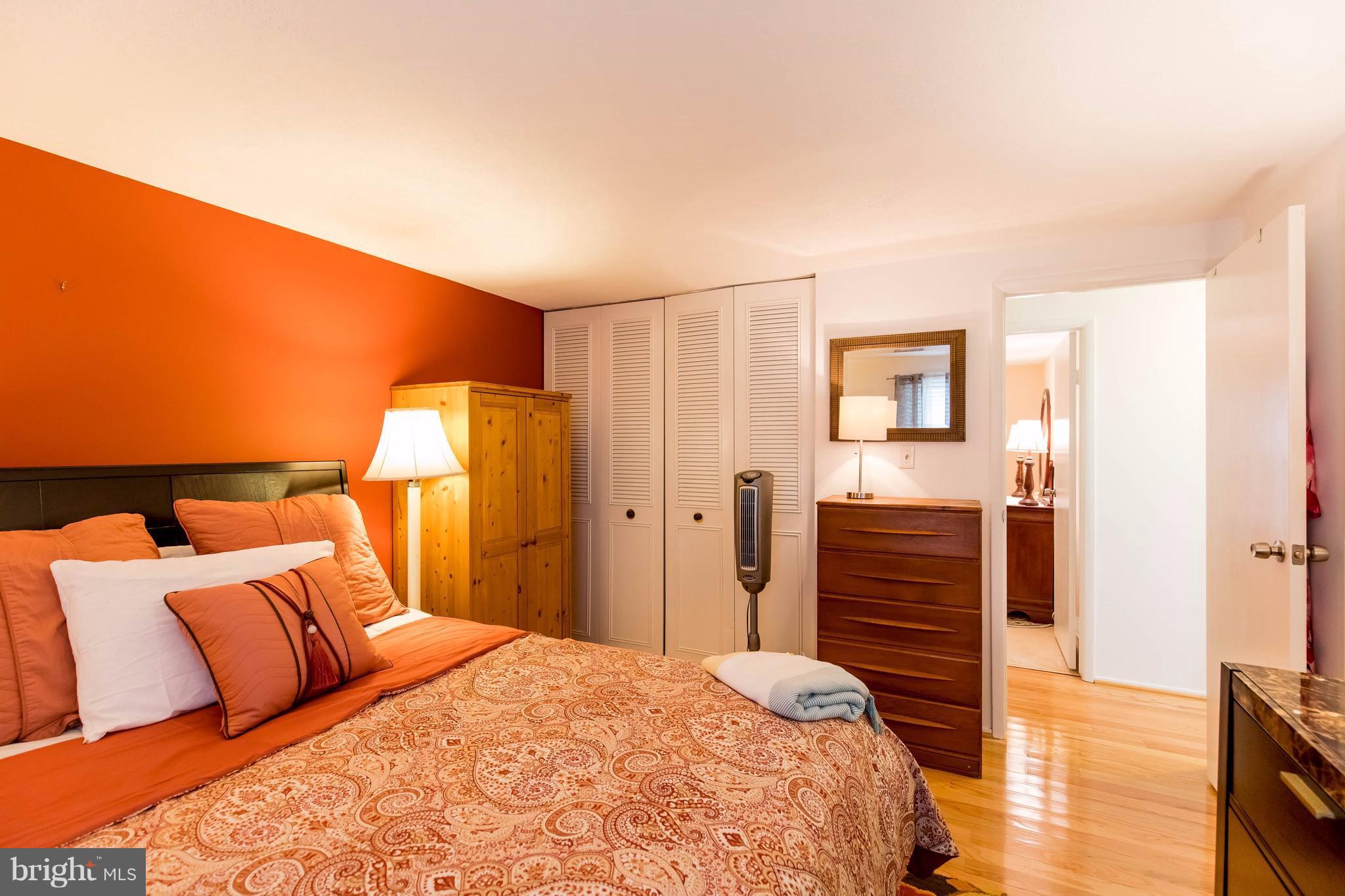 12255 Turkey Wing Court Reston, VA 20191 - Photo 18 of 30 a bedroom with a bed and wooden floor