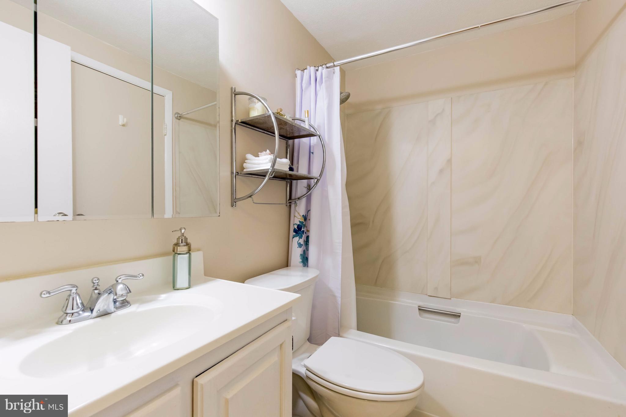 12255 Turkey Wing Court Reston, VA 20191 - Photo 21 of 30 a bathroom with a sink toilet vanity and shower