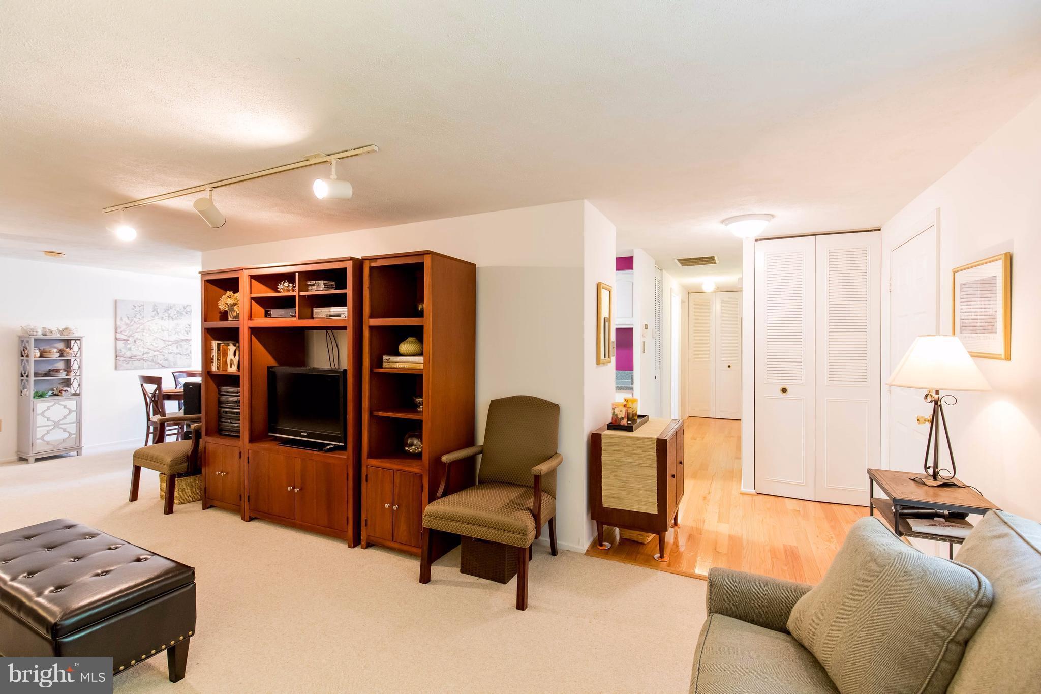 12255 Turkey Wing Court Reston, VA 20191 - Photo 5 of 30 a living room with furniture and a flat screen tv