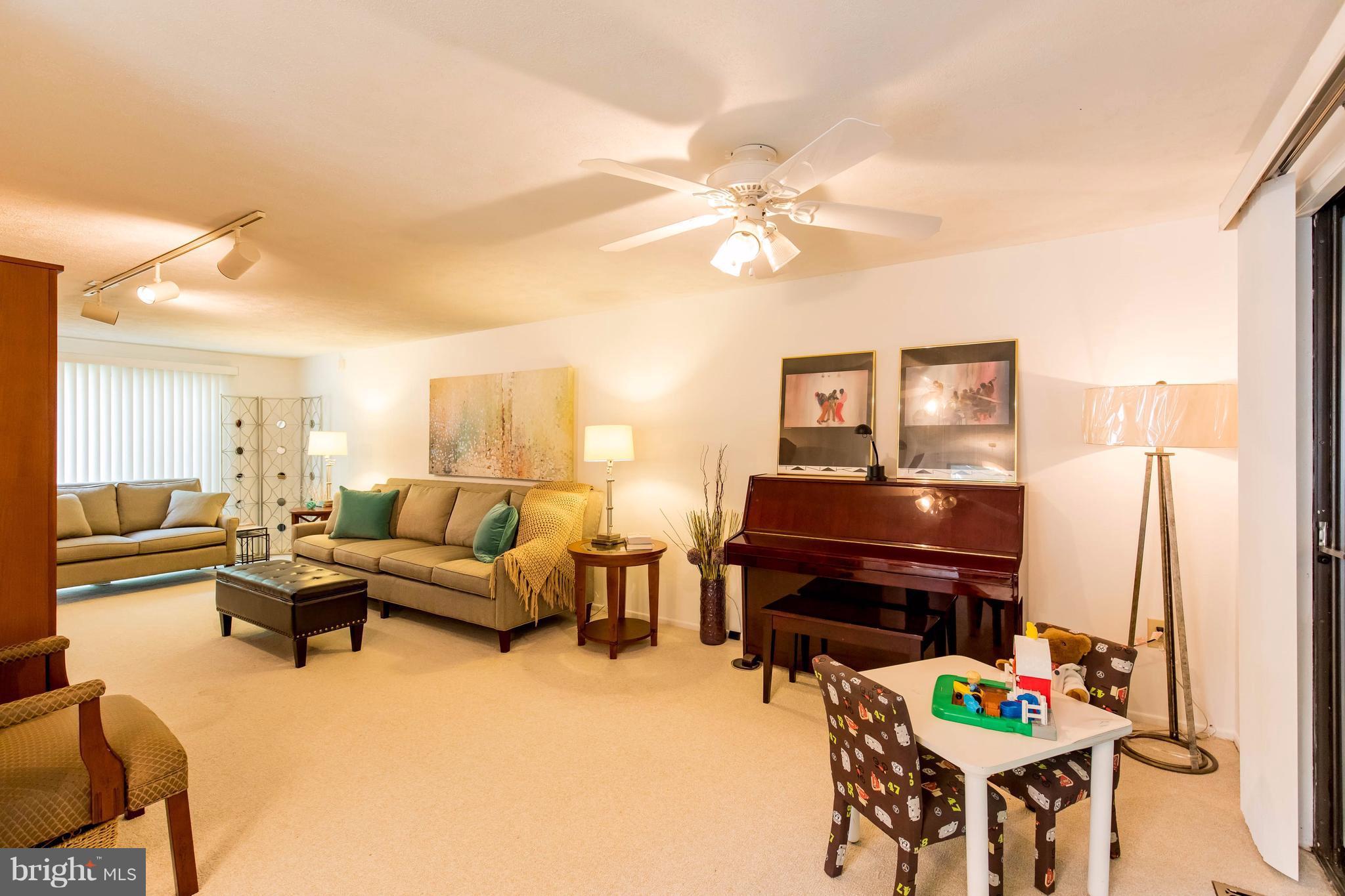 12255 Turkey Wing Court Reston, VA 20191 - Photo 6 of 30 a living room with furniture and a chandelier