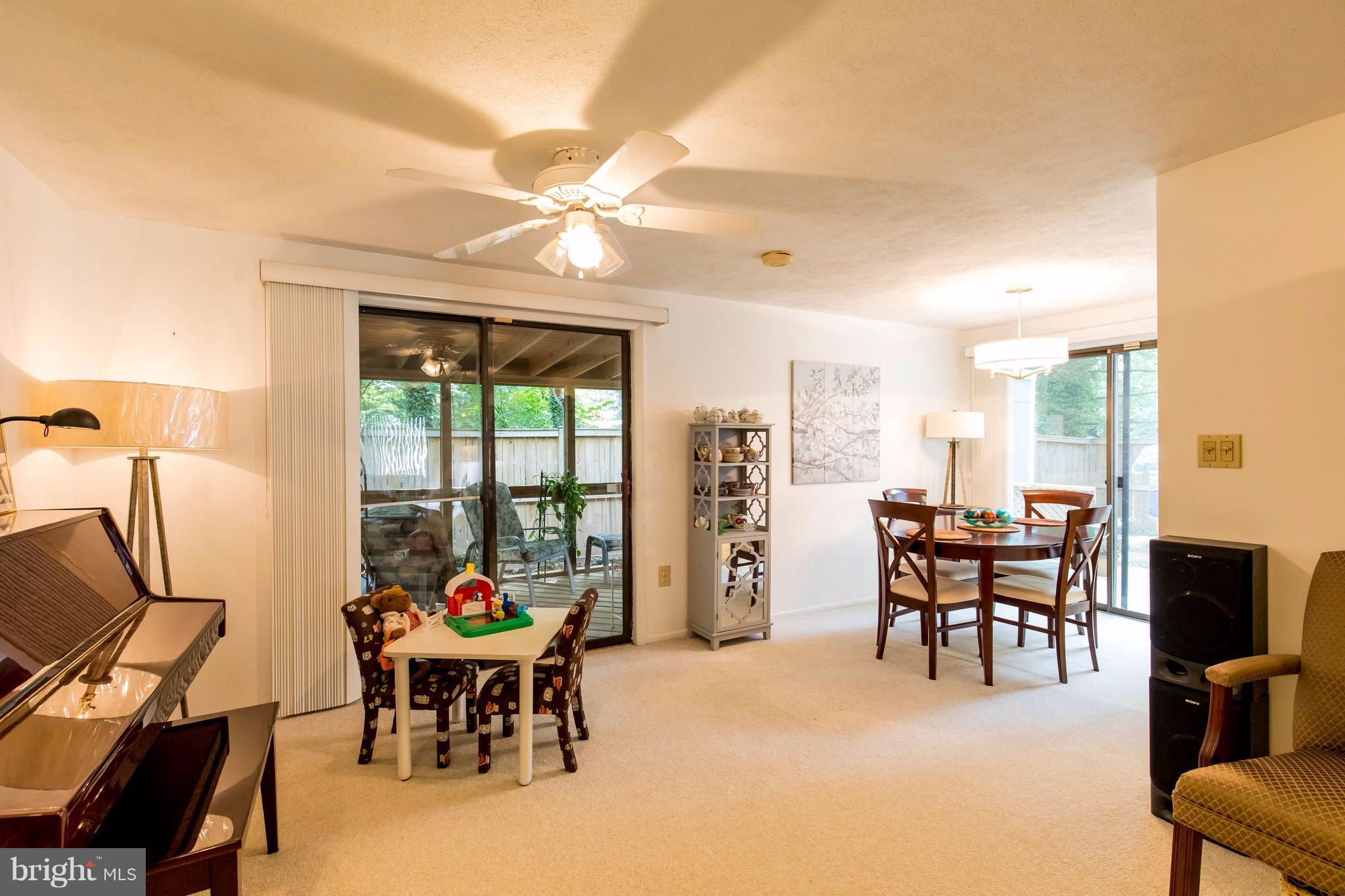 12255 Turkey Wing Court Reston, VA 20191 - Photo 7 of 30 a dining room with furniture garden view and a chandelier