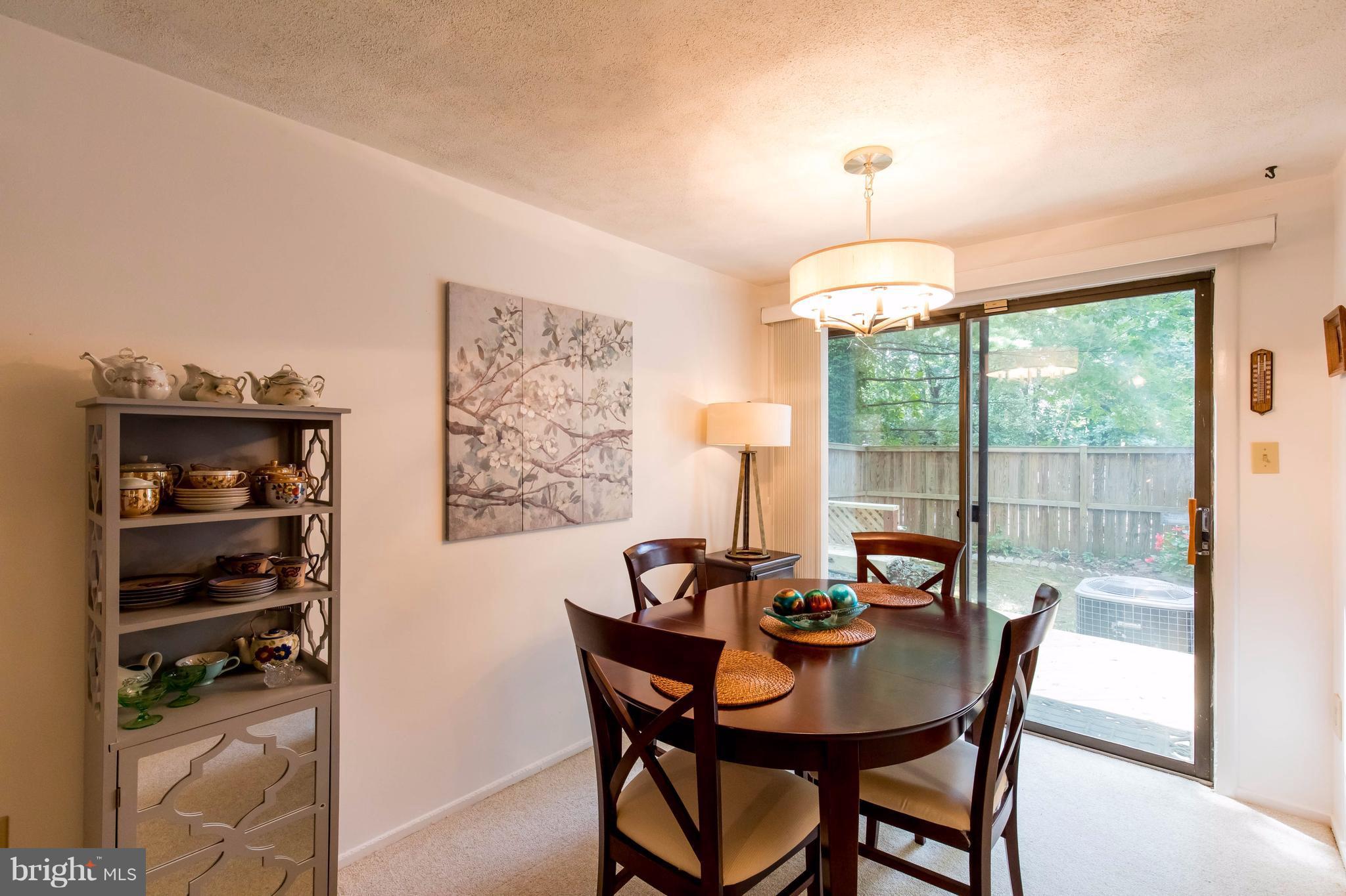12255 Turkey Wing Court Reston, VA 20191 - Photo 10 of 30 a view of a dining room with furniture window and outside view