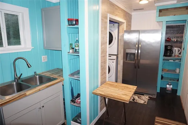 a kitchen with a sink and wooden floor