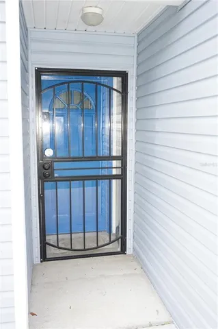 a view of a backyard with a barn and large trees