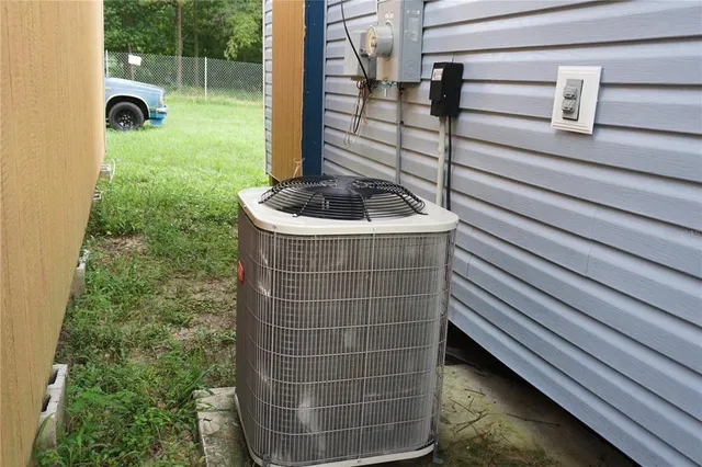 a view of a green field with trees in the background