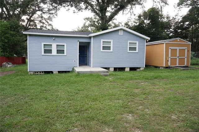 a view of a street with a yard of the house