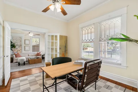 a dining room with furniture and wooden floor