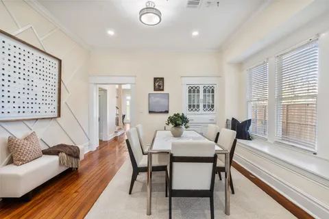 a view of a a dining room with furniture window and wooden floor