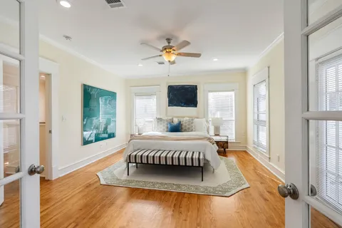 a living room with a bed furniture and a flat tv screen
