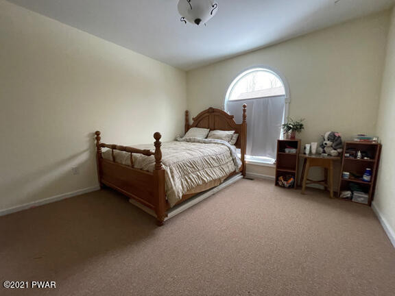 184 Skyview Road Dingmans Ferry, PA 18328 - Photo 15 of 26 a spacious bedroom with a bed and a chandelier