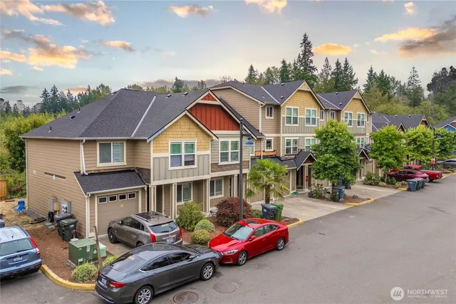 a front view of a house with a garden and plants