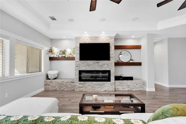 a living room with furniture a flat screen tv and a fireplace