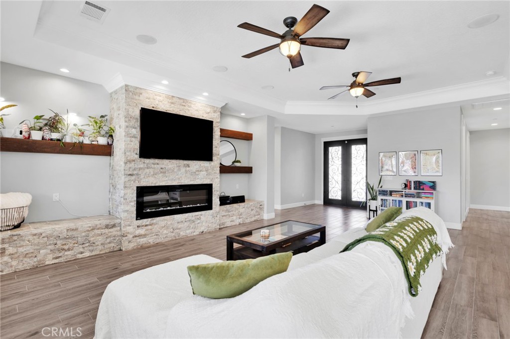 12634 Spring Valley Parkway Victorville, CA 92395 - Photo 12 of 42 a living room with furniture a fireplace and a flat screen tv