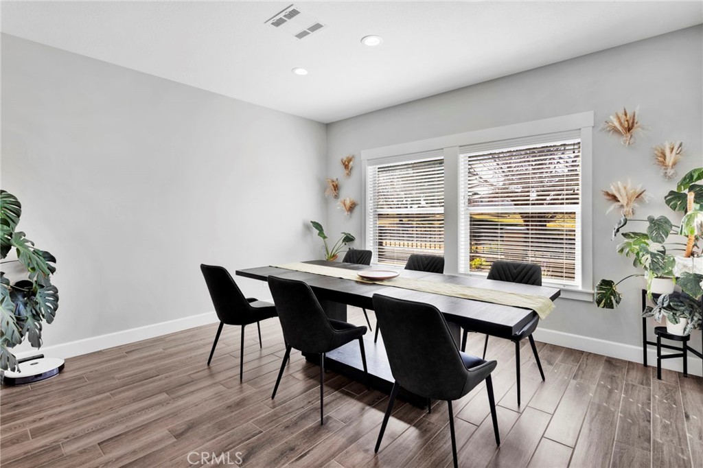 12634 Spring Valley Parkway Victorville, CA 92395 - Photo 16 of 42 a view of a dining room with furniture window and wooden floor