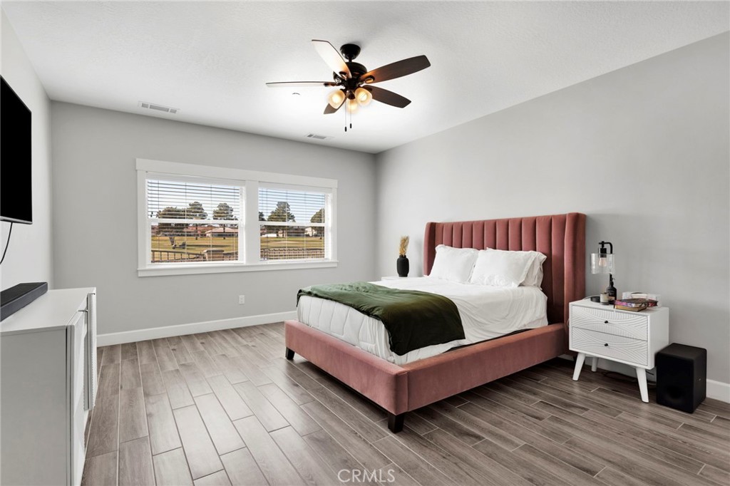 12634 Spring Valley Parkway Victorville, CA 92395 - Photo 21 of 42 a spacious bedroom with a bed and a window