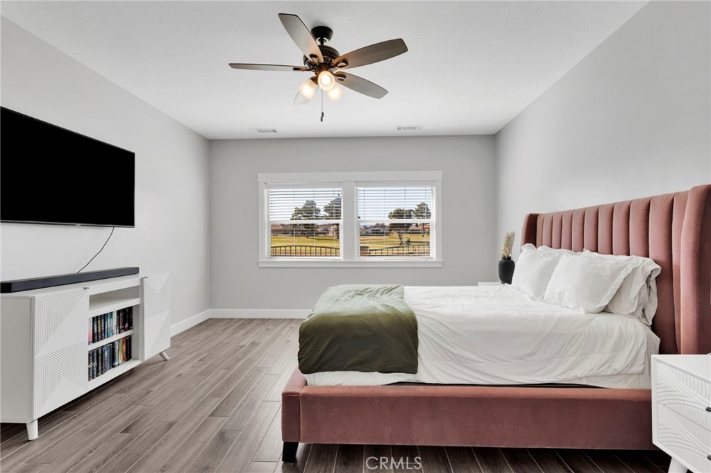 12634 Spring Valley Parkway Victorville, CA 92395 - Photo 23 of 42 a bedroom with a bed and a flat screen tv