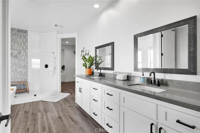 a spacious bathroom with double vanity and a mirror