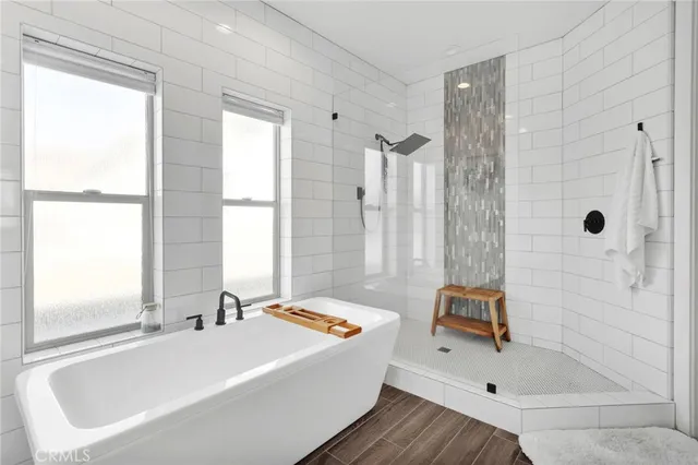 a white bath tub sitting next to a white sink