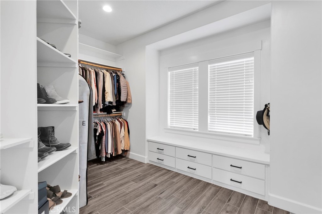12634 Spring Valley Parkway Victorville, CA 92395 - Photo 27 of 42 a view of walk in closet with clothes and shoes