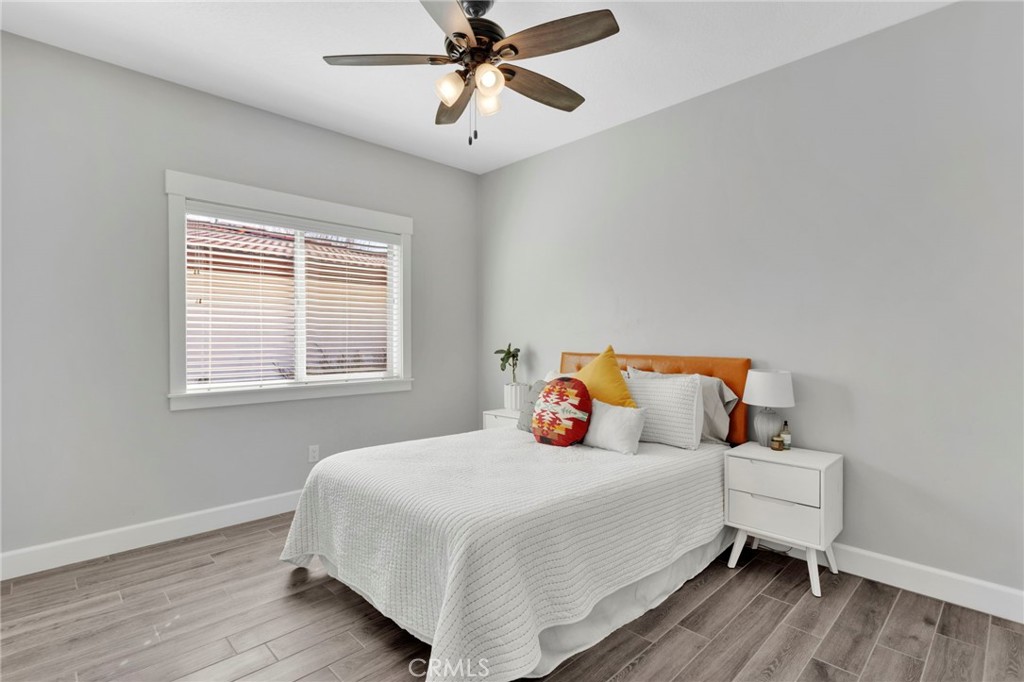 12634 Spring Valley Parkway Victorville, CA 92395 - Photo 29 of 42 a bedroom with a bed and wooden floor