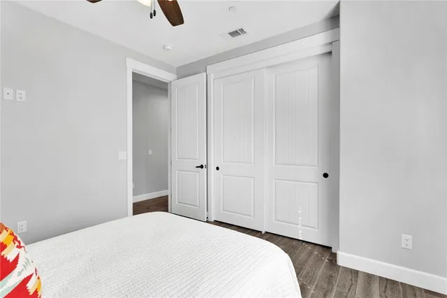 a bedroom with a bed and wooden floor