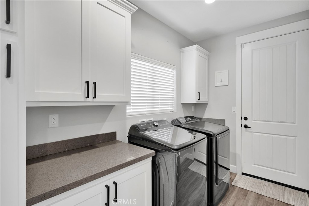 12634 Spring Valley Parkway Victorville, CA 92395 - Photo 31 of 42 a kitchen with a sink a stove and cabinets