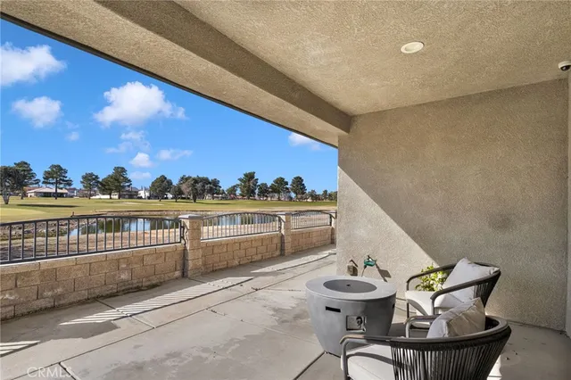 a balcony with a table and chairs