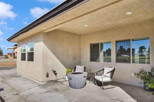 a view of a chairs and table in the patio