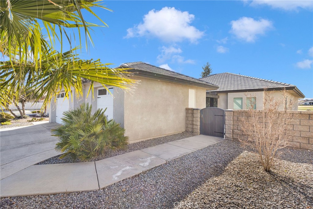 12634 Spring Valley Parkway Victorville, CA 92395 - Photo 5 of 42 a front view of a house with a garden