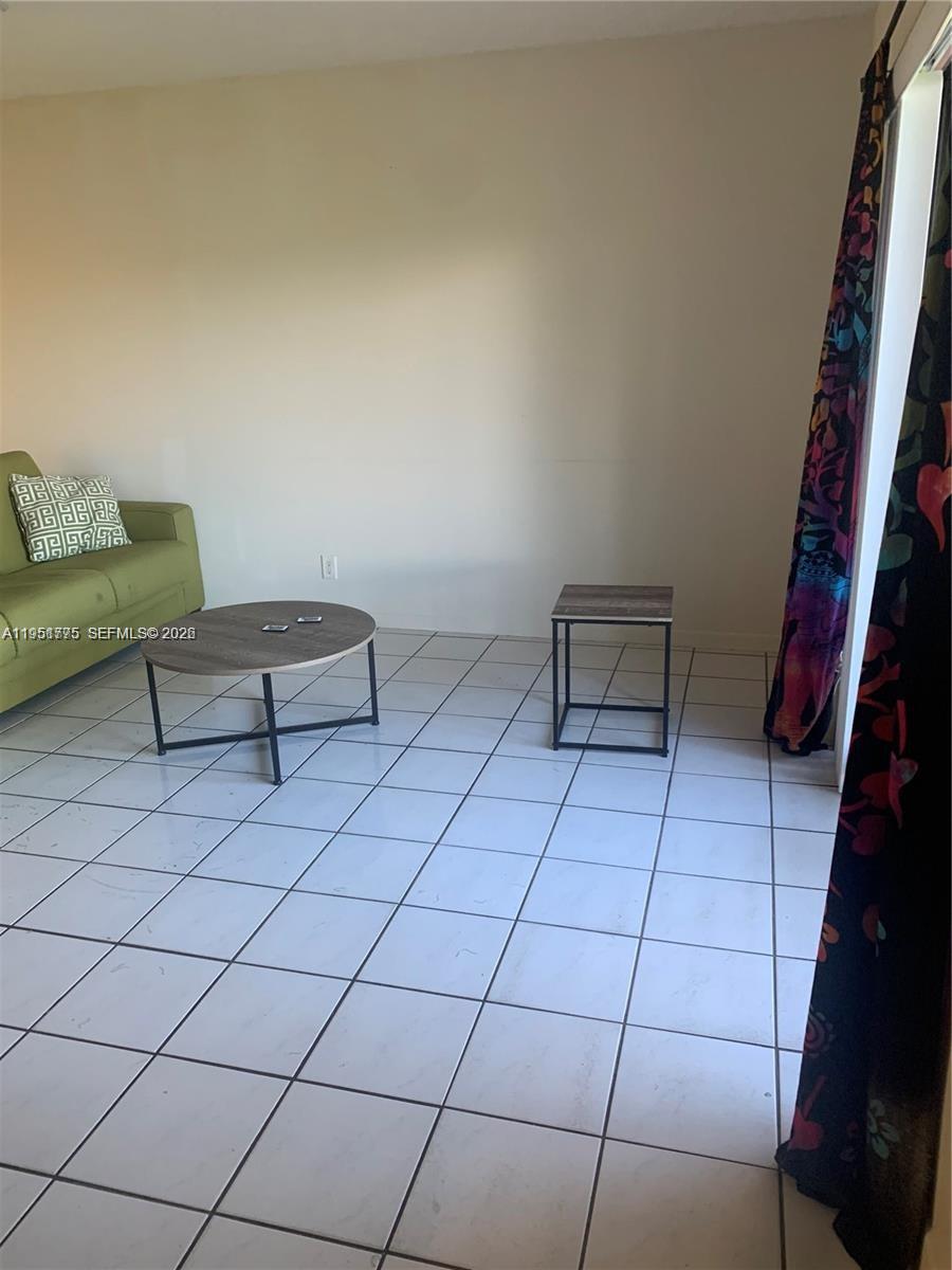 10009 Winding Lake Road, Unit 106 Sunrise, FL 33351 - Photo 4 of 7 a view of an empty room and wooden floor