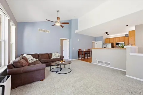 a living room with furniture and kitchen view