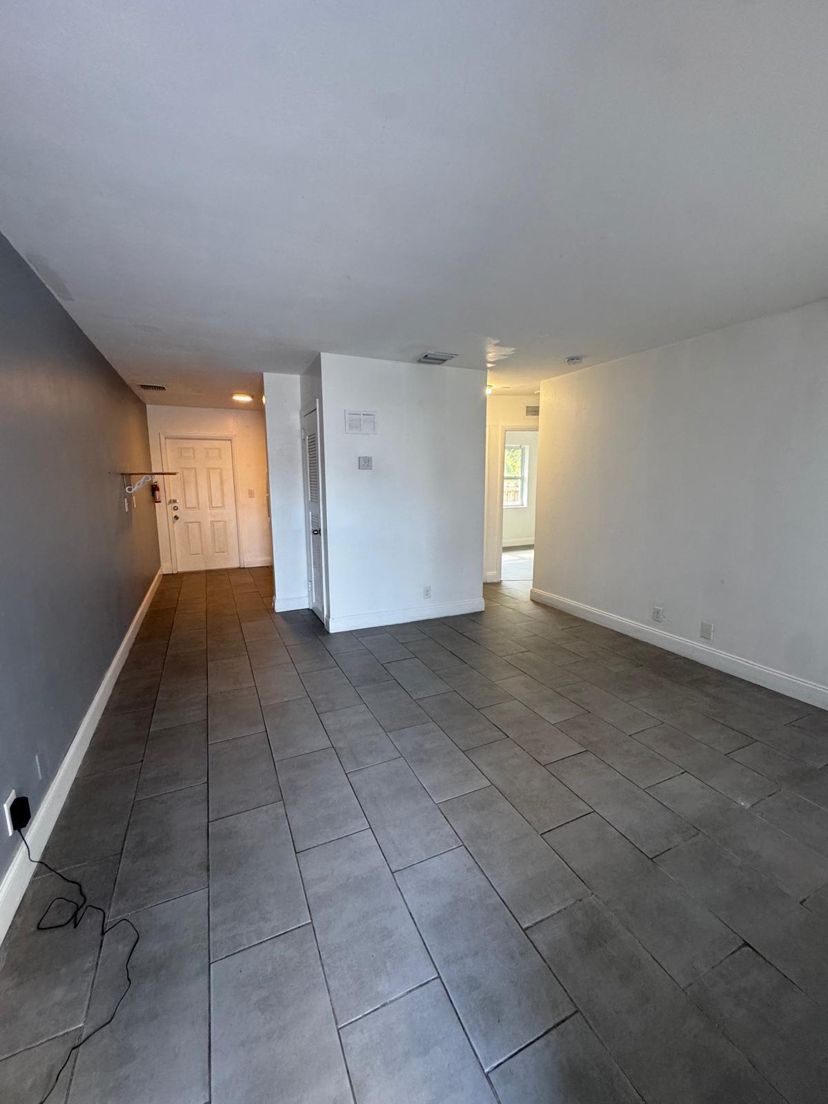 914 3rd Street, Unit 4 West Palm Beach, FL 33401 - Photo 3 of 17 a view of a livingroom with an empty space and a window