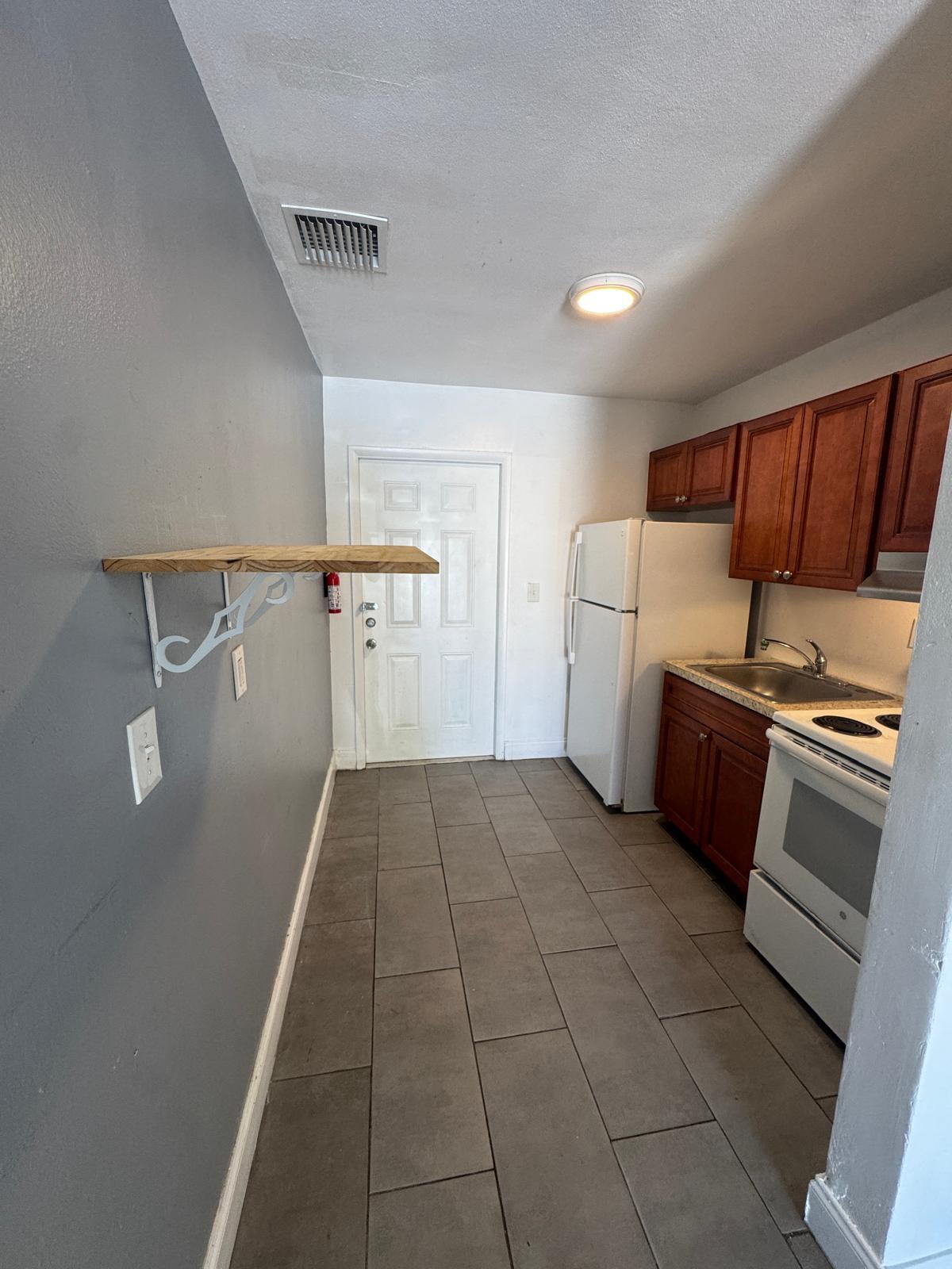914 3rd Street, Unit 4 West Palm Beach, FL 33401 - Photo 9 of 17 a kitchen with a refrigerator and a sink