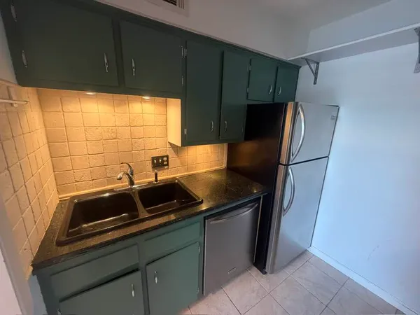 a kitchen with stainless steel appliances a refrigerator and a sink