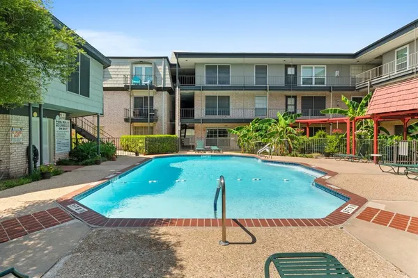 a view of building with a swimming pool