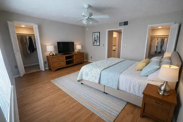 a bedroom with a bed and wooden floor