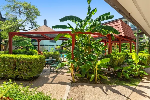 a view of a patio with table and chairs and potted plants