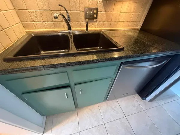 a close view of sink and washing machine