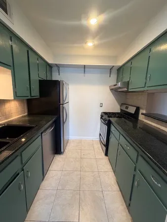 a kitchen with a refrigerator and a sink