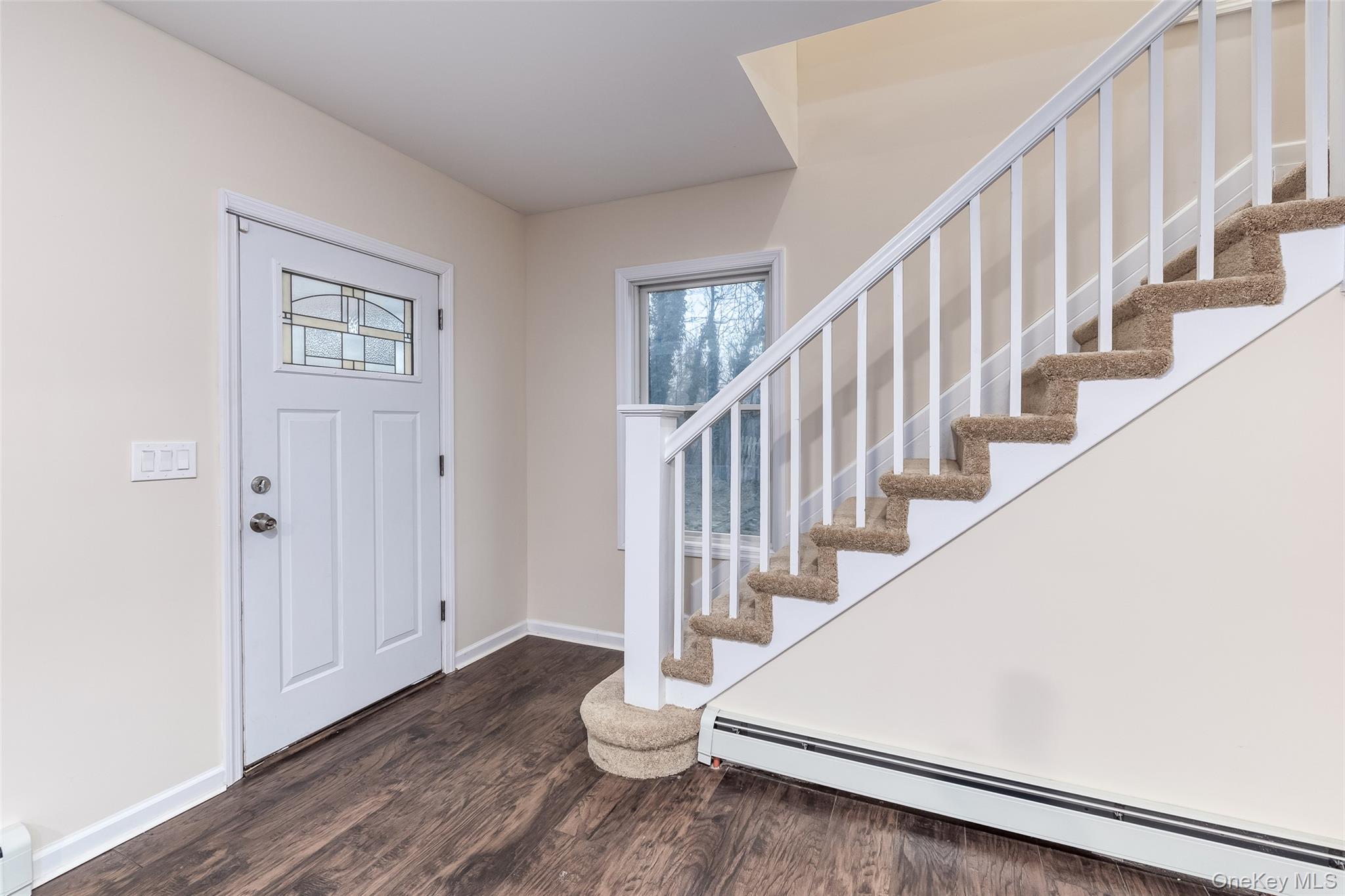 30170 Main Road Cutchogue, NY 11935 - Photo 2 of 9 a view of staircase with wooden floor and white walls